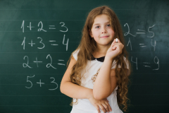 schoolgirl-smiling-blackboard-class